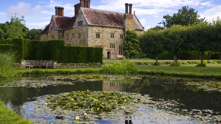House reflection on the lily pond at Bateman's, East Sussex